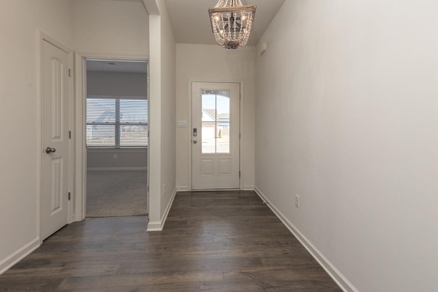 doorway to outside featuring dark hardwood / wood-style flooring and a notable chandelier