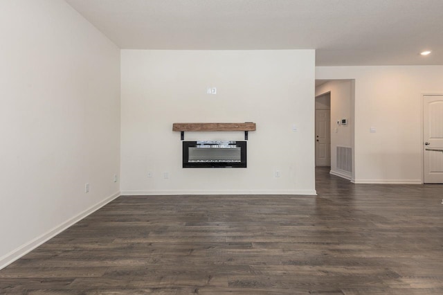 unfurnished living room featuring dark hardwood / wood-style flooring