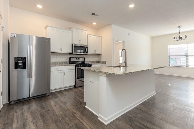 kitchen with stainless steel appliances, a kitchen island with sink, white cabinets, and sink