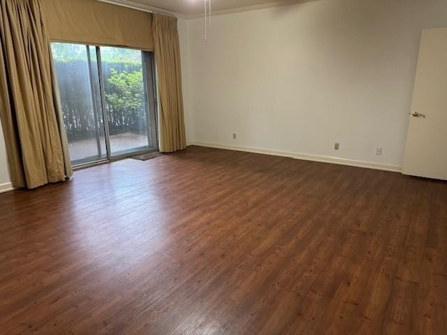 empty room with crown molding and dark hardwood / wood-style floors