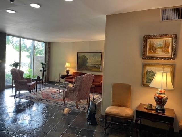 living area with floor to ceiling windows