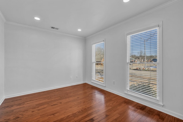 spare room with ornamental molding and hardwood / wood-style flooring