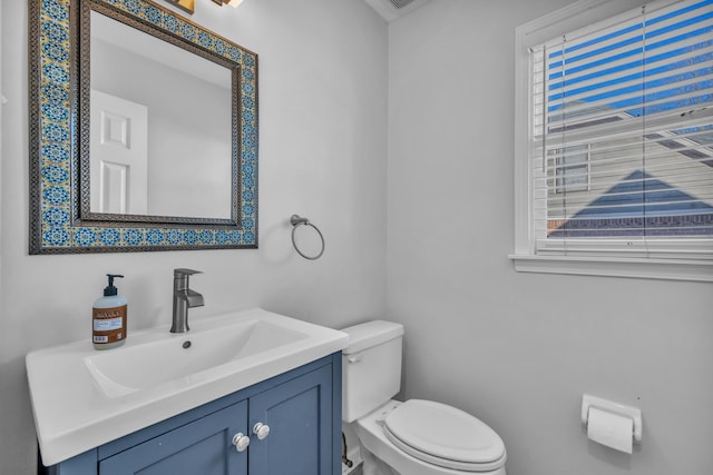 bathroom with toilet and vanity