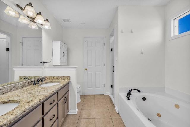 bathroom featuring toilet, a bathing tub, tile patterned flooring, and vanity