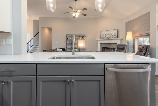 kitchen with sink, stainless steel dishwasher, gray cabinetry, and crown molding