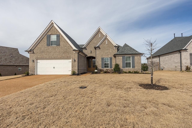 view of front of property with a front yard and a garage