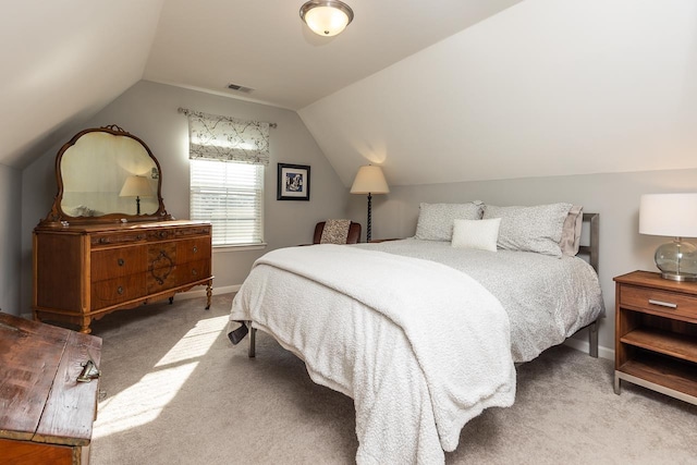 carpeted bedroom with vaulted ceiling