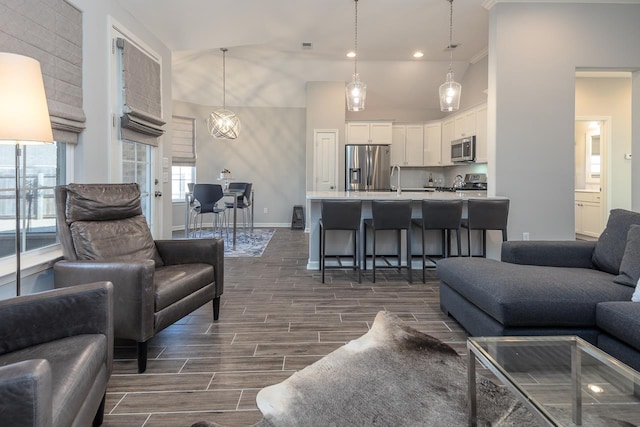 living room with sink and a towering ceiling