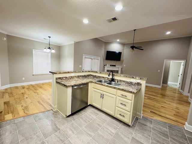 kitchen featuring ceiling fan with notable chandelier, dishwasher, decorative light fixtures, sink, and stone countertops