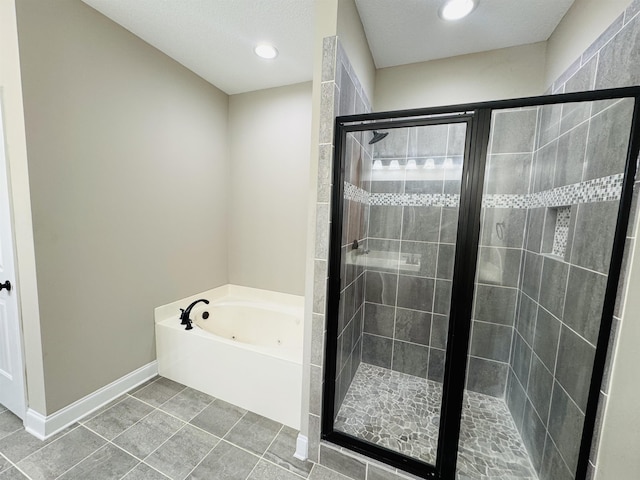 bathroom with plus walk in shower and tile patterned flooring