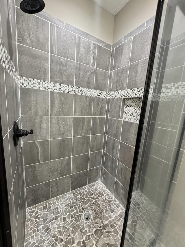 bathroom with tiled shower