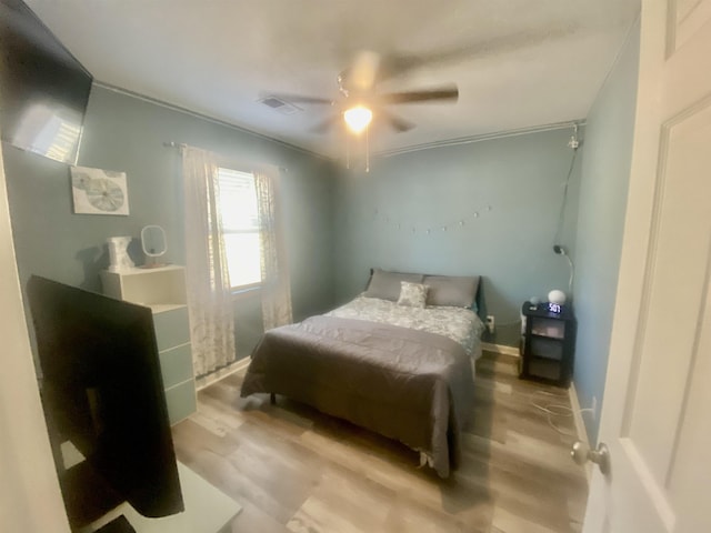 bedroom featuring ceiling fan and light hardwood / wood-style floors