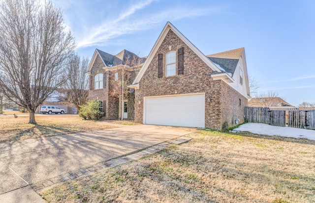 view of front of property featuring a front yard and a garage