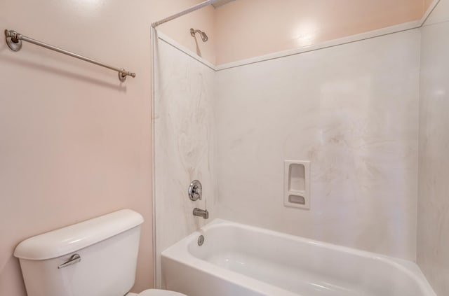 bathroom with shower / bath combination and toilet