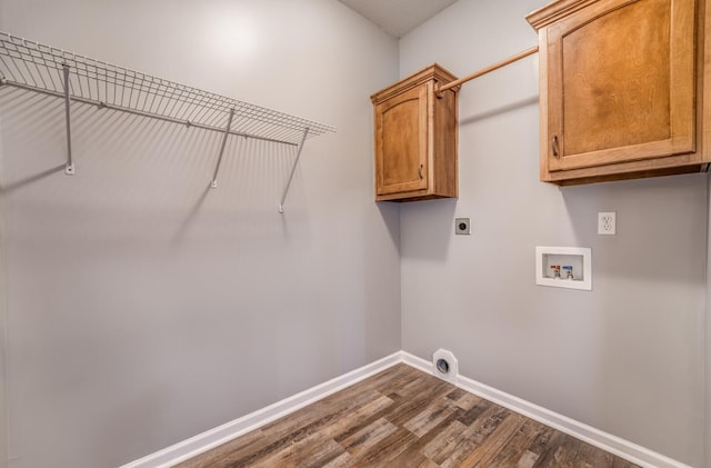 laundry area featuring dark hardwood / wood-style flooring, washer hookup, electric dryer hookup, and cabinets