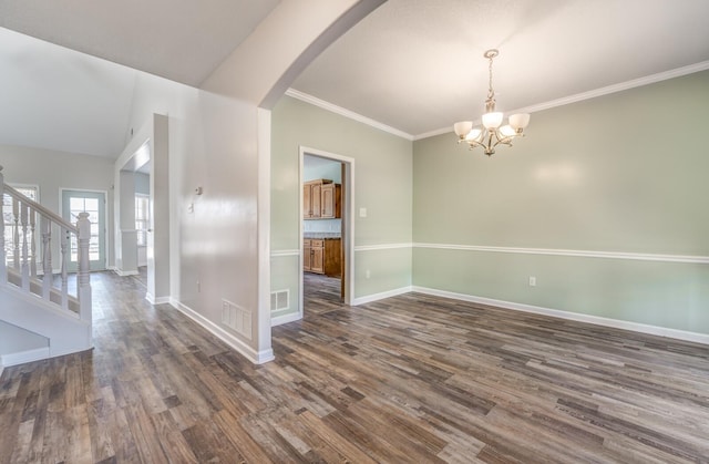 unfurnished room featuring a chandelier, lofted ceiling, ornamental molding, and dark hardwood / wood-style flooring