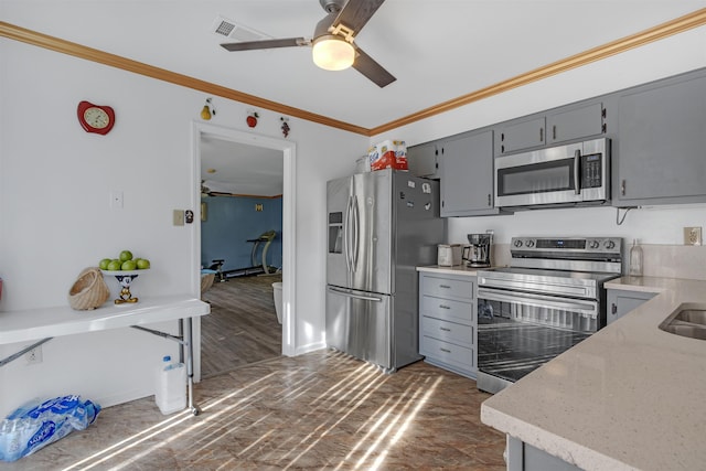 kitchen with ceiling fan, gray cabinetry, crown molding, and stainless steel appliances