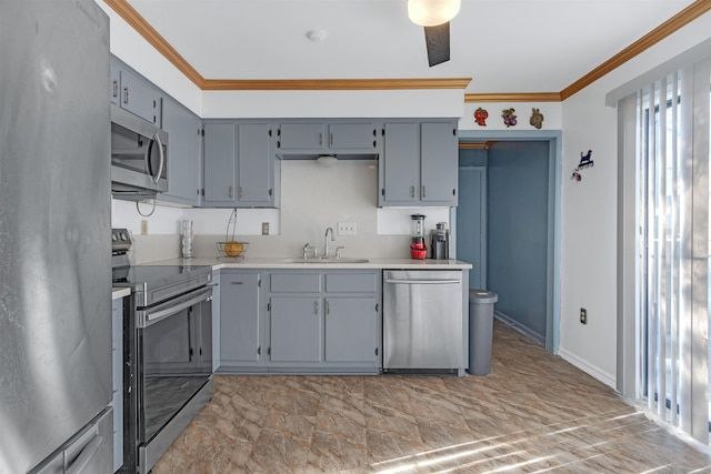 kitchen with gray cabinetry, appliances with stainless steel finishes, sink, and crown molding