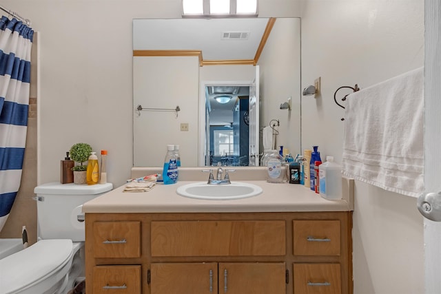 bathroom featuring toilet, vanity, walk in shower, and ornamental molding