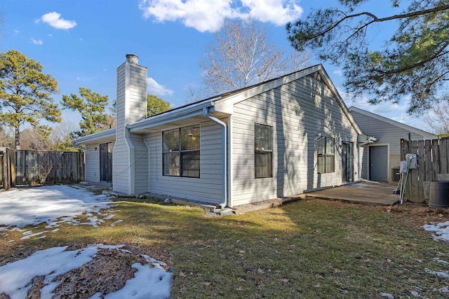 view of side of home with a yard and a patio