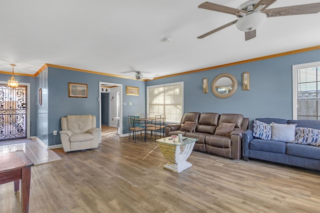 living room featuring ceiling fan, wood-type flooring, and ornamental molding