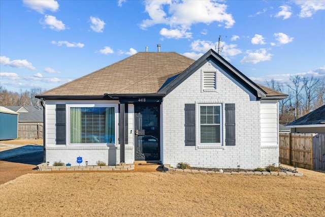 bungalow-style home with a front yard