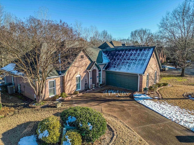 view of front of property with a garage and cooling unit