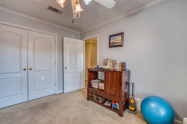 misc room with ceiling fan, ornamental molding, and light colored carpet