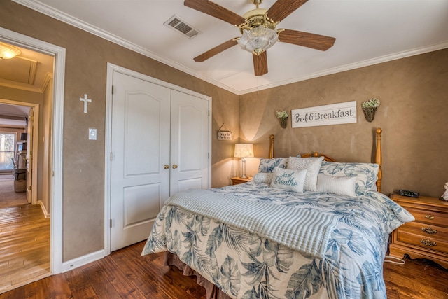 bedroom with ceiling fan, a closet, dark hardwood / wood-style flooring, and crown molding