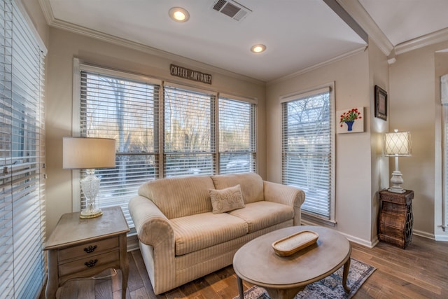 living room with plenty of natural light, ornamental molding, and hardwood / wood-style floors