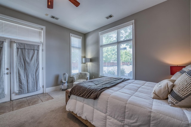 bedroom with ceiling fan and light colored carpet