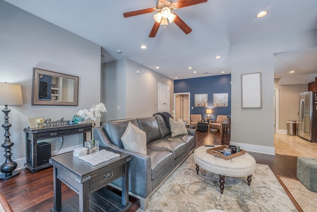 living room featuring ceiling fan and hardwood / wood-style floors