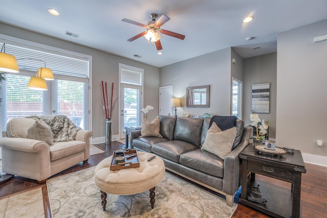 living room featuring ceiling fan and hardwood / wood-style floors