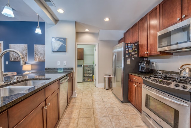 kitchen featuring sink, pendant lighting, appliances with stainless steel finishes, and dark stone countertops