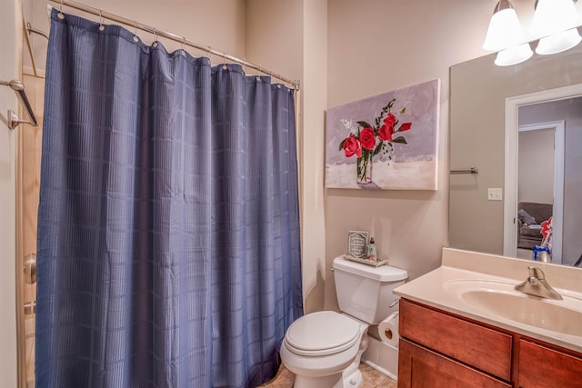 bathroom with toilet, vanity, and a shower with shower curtain