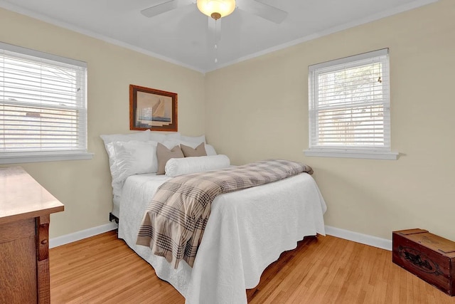 bedroom featuring ceiling fan, ornamental molding, and light hardwood / wood-style floors