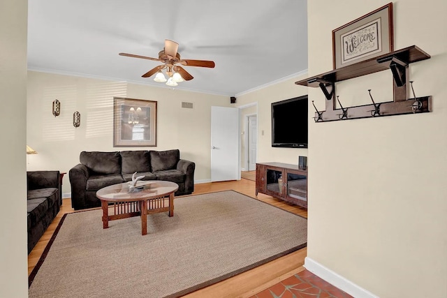 living room with ceiling fan, ornamental molding, and hardwood / wood-style flooring