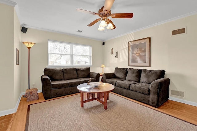 living room with light hardwood / wood-style floors, crown molding, and ceiling fan