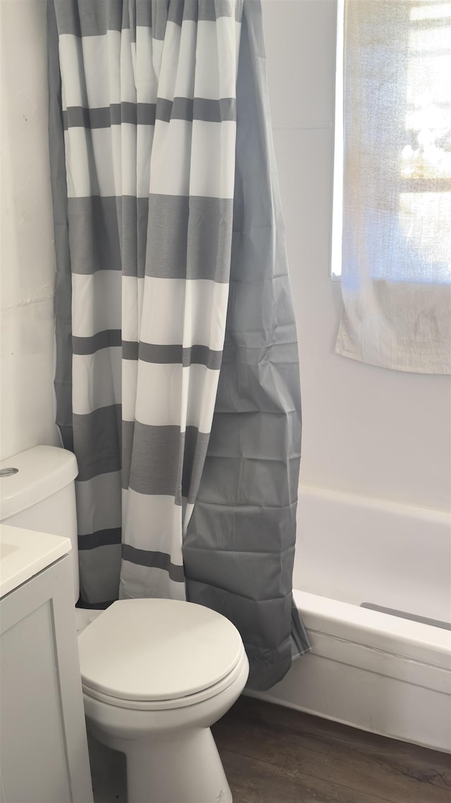 full bathroom with toilet, vanity, shower / tub combo with curtain, and hardwood / wood-style floors