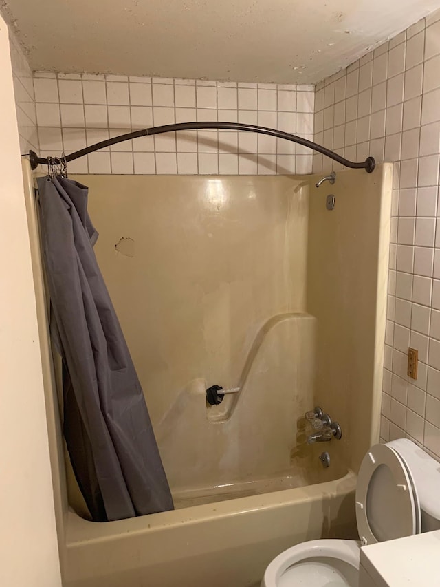 bathroom with toilet and shower / tub combo with curtain