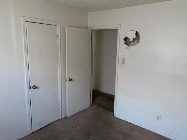 unfurnished bedroom with a textured ceiling