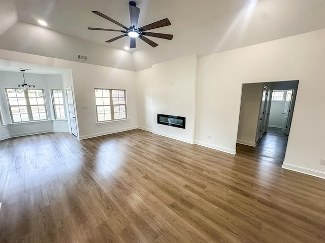 2827 Epping Crest Cv, Memphis, TN 38128 - unfurnished living room with vaulted ceiling, dark hardwood / wood-style floors, and ceiling fan with notable chandelier