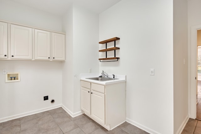 washroom with cabinets, sink, hookup for a washing machine, hookup for an electric dryer, and light tile patterned floors