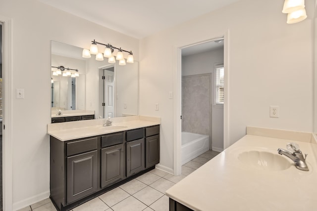 bathroom with a bathing tub, tile patterned floors, and vanity