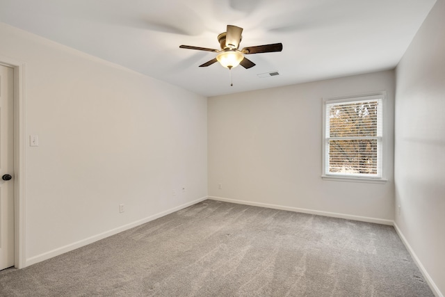 unfurnished room with ceiling fan and light colored carpet