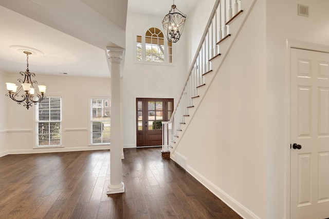 entrance foyer featuring dark wood-type flooring, french doors, a notable chandelier, and ornamental molding