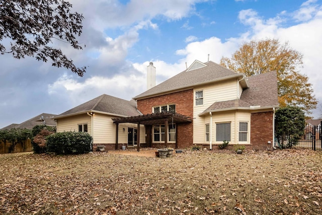 rear view of house featuring a pergola