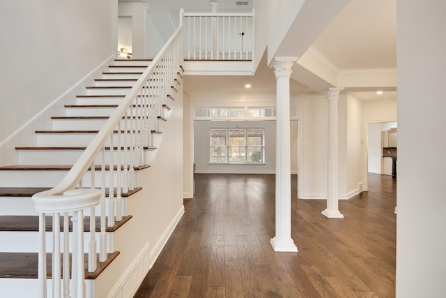 stairway with wood-type flooring and crown molding