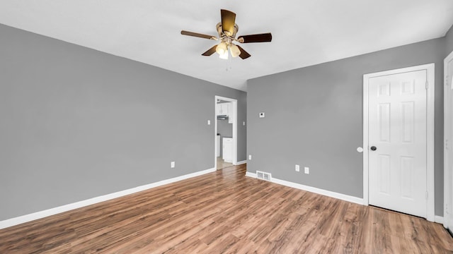 spare room with ceiling fan and hardwood / wood-style flooring