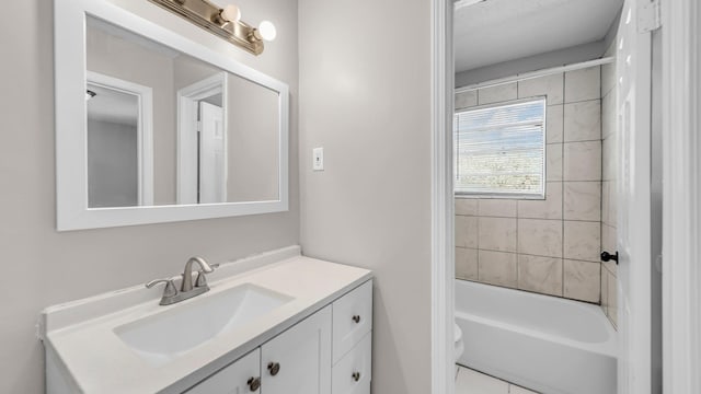 full bathroom featuring toilet, tiled shower / bath, and vanity